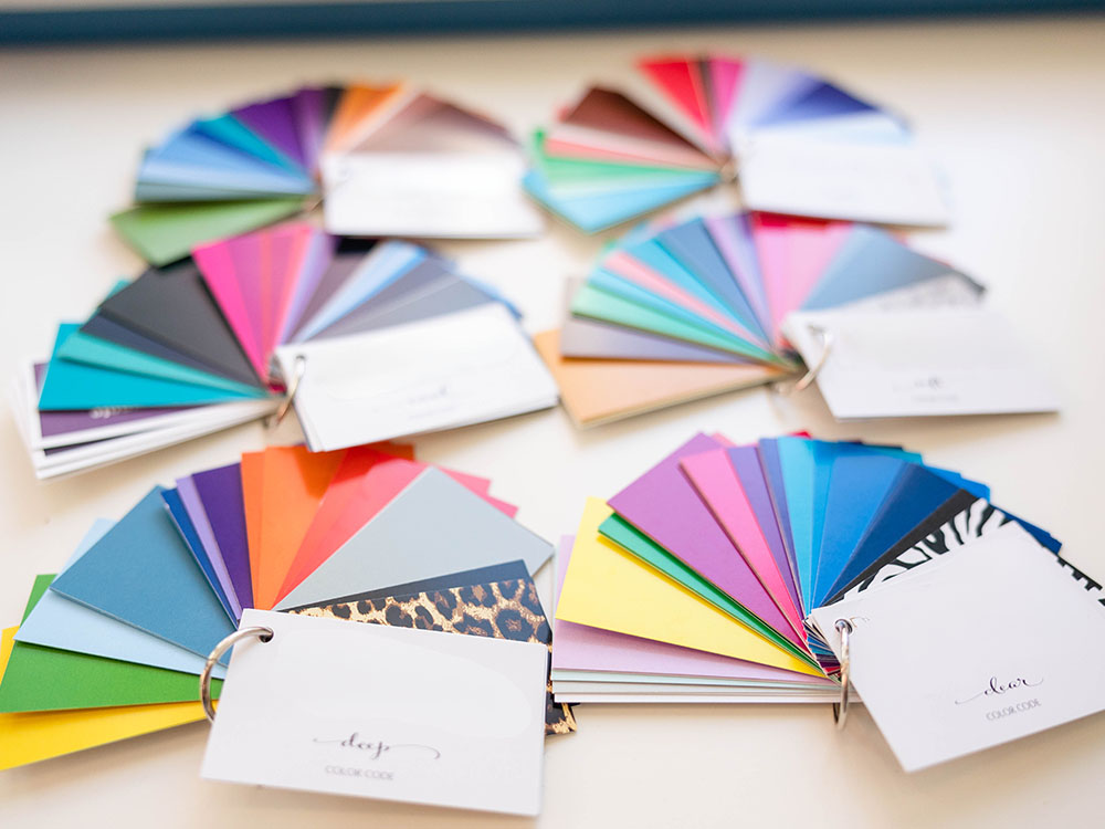 Photo of colorful groupings of paper samples with color packets.